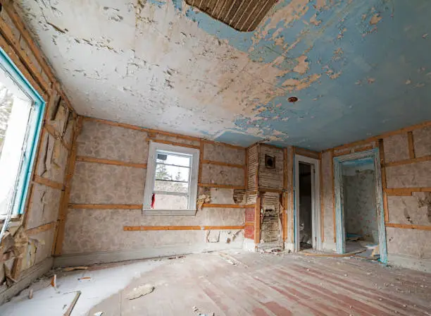 Inside an abandoned house. Walls falling apart. Ceiling damaged.