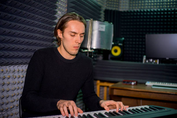 istock Musician in a recording studio 902623542