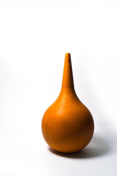 istock Old orange enema on a white background 902626728