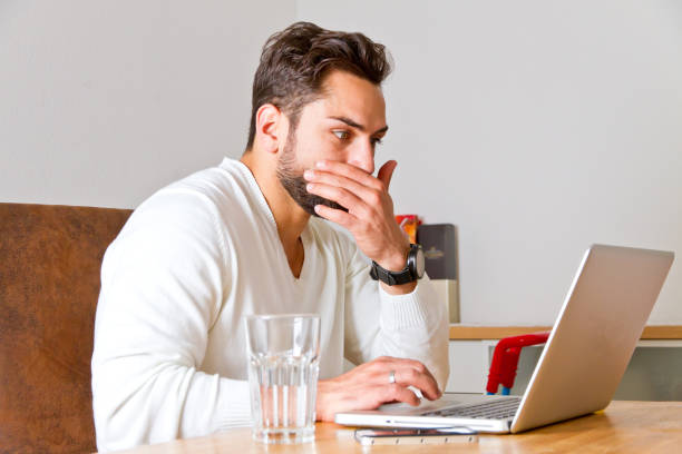 istock Young man on laptop have trouble 902628374