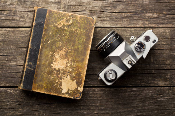 istock the vintage 35mm film camera and old book 902631678