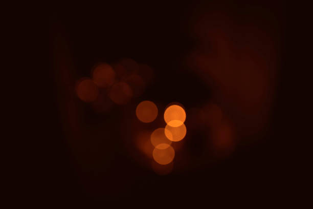 istock Bokeh lights in orange golden colors on brown background 902631842