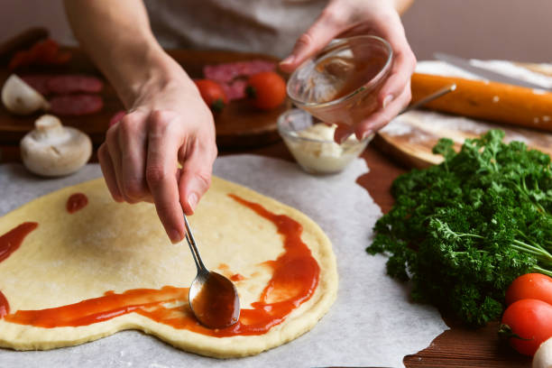 シェフは、バレンタインの日の休日のためピザ心をなります。サラミとモッツァレラチーズの古典的なイタリアのピザ - cheese making ストックフォトと画像