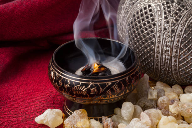 Frankincense Frankincense burning on a hot coal. Frankincense is an aromatic resin, used for religious rites, incense and perfumes. incense photos stock pictures, royalty-free photos & images