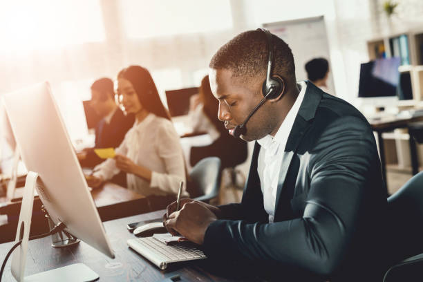 istock A black guy works in a call center. 902646640