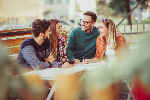 istock Group of four friends having fun a coffee together. 902648194
