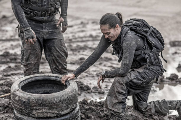 istock Female drill instructor training shaved male soldier outdoors in the mud 902651554