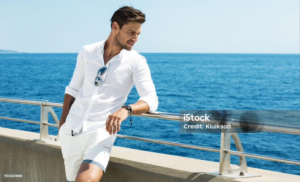 Handsome male Handsome man wearing white clothes posing in sea scenery Men Stock Photo