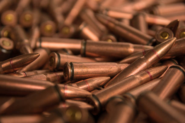 ammunition fo ak-47 close up of ammunition fo ak-47 in color of copper ak 47 bullets stock pictures, royalty-free photos & images