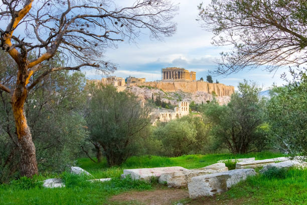 istock Acropolis with Parthenon. View through a frame of green plants, trees and ancient marbles, Athens, Greece. 902658328