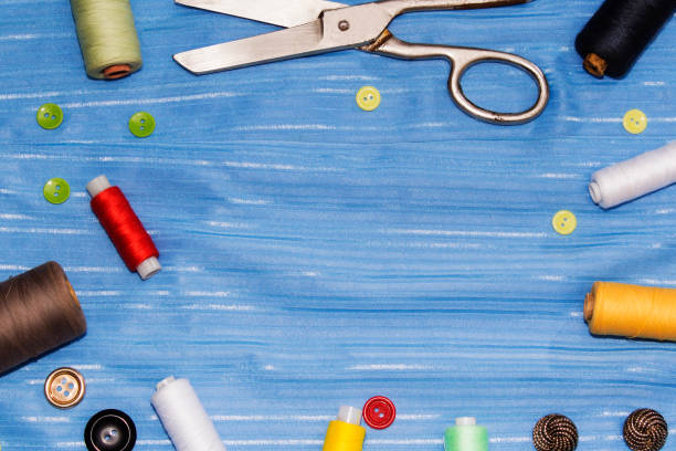 istock Background of sewing: scissors, thread, needles, measuring tape close up top view. 902658370
