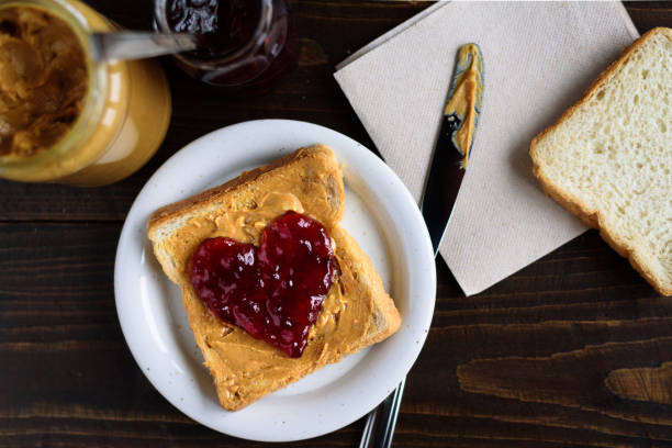 istock Peanut butter and heart shaped jelly sandwich 902659504