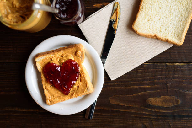 istock Peanut butter and heart shaped jelly sandwich 902659640