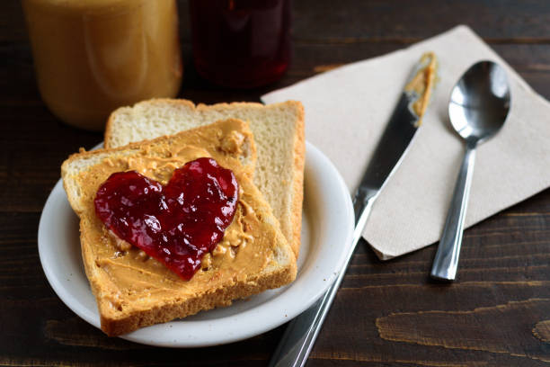 istock Peanut butter and heart shaped jelly sandwich 902659700
