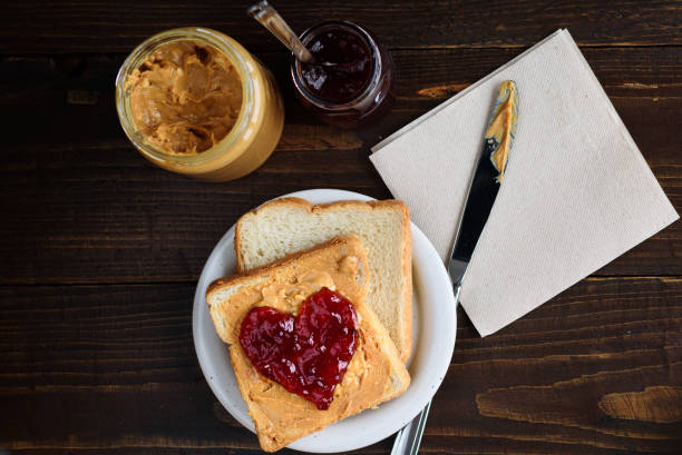 istock Peanut butter and heart shaped jelly sandwich 902659740