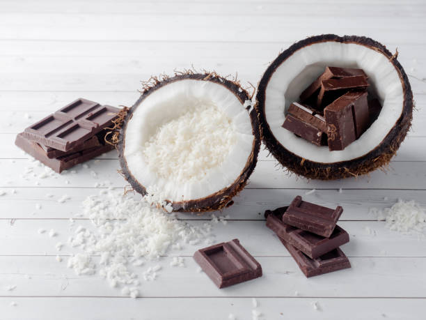 istock Fresh organic coconut broken into two parts with chocolate on a rustic wooden background 902662202