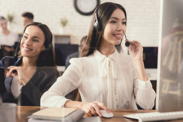 istock Asian girl posing on camera, sitting at computer. 902663306