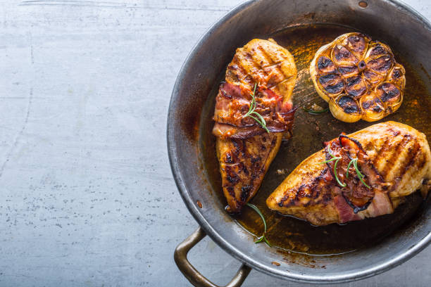 istock Grill chicken Breast. Roasted chicken breast with bacon and garlic in pan 902666324