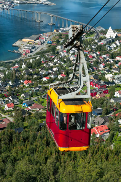 Cable car above Tromso city, Norway Cable car above Tromso city with the bridge and Arctic Cathedral on background, Norway tromso stock pictures, royalty-free photos & images