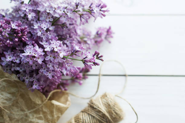 istock lilac flowers on white old wooden background 902669404