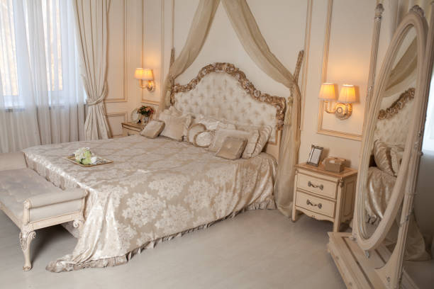 istock Big comfortable double bed in elegant classic bedroom 902673528