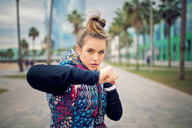 istock Runner girl is boxing along the beach after a long run 902673636