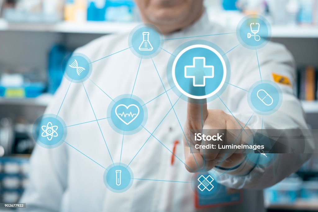 Doctor using healthcare application. Male doctor using healthcare application on touch screen in medical laboratory. Pharmacy Stock Photo