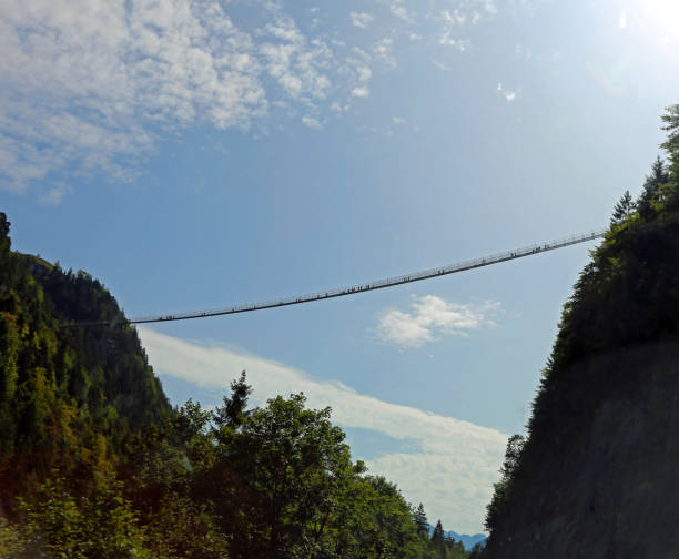 istock long suspension bridge between two mountains with many intrepid adventurers who pass through it 902680776