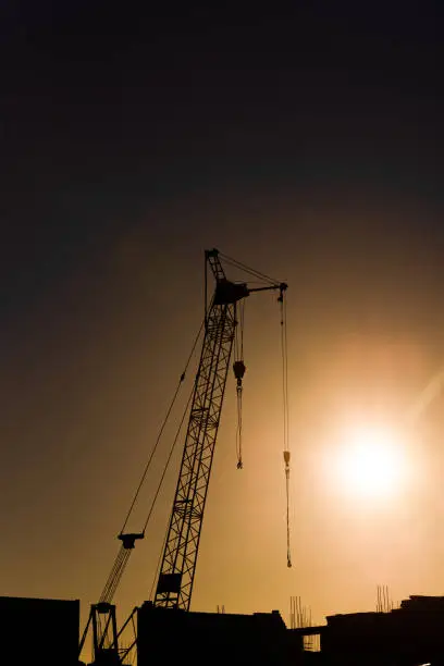 silhouette tower·crane of construction site at sunset