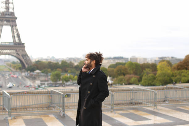istock Arabian boy walking near Eiffel Tower with smartphone in slow mo 902691134