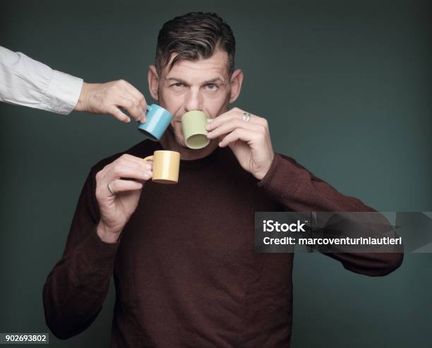 Man In A Rush To Drink His Coffee Stock Photo - Download Image Now - Coffee - Drink, Espresso, Excess