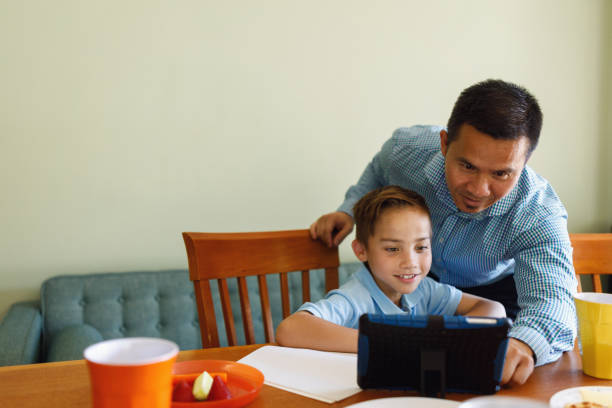 istock Father Helping Children Do Homework After School 902696796