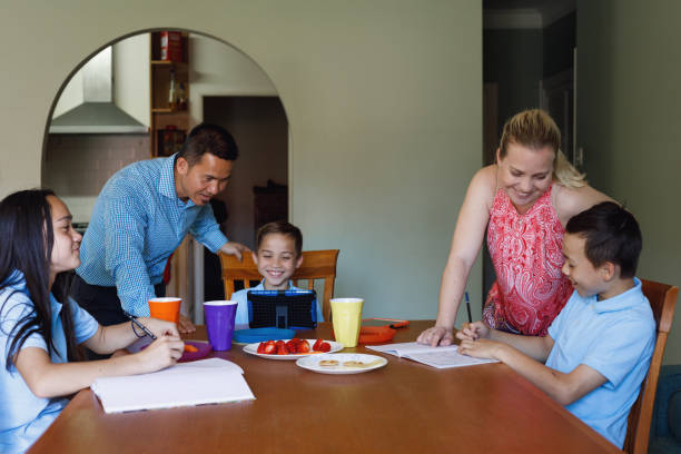 istock Parents Helping Children Do Homework After School 902703540