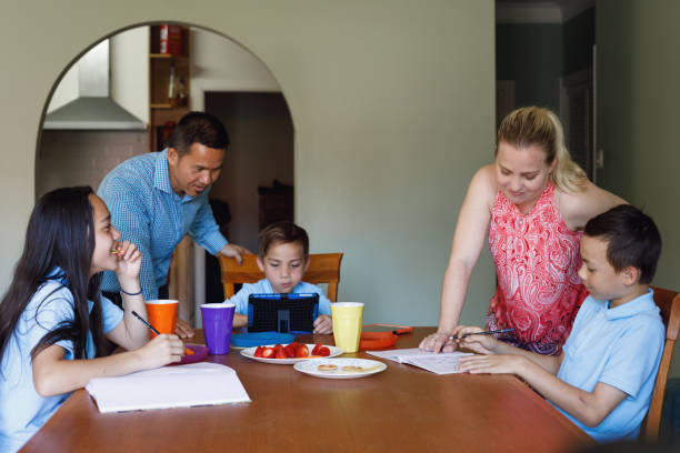 istock Parents Helping Children Do Homework After School 902705914