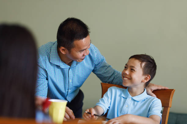 istock Father Helping Children Do Homework After School 902706210