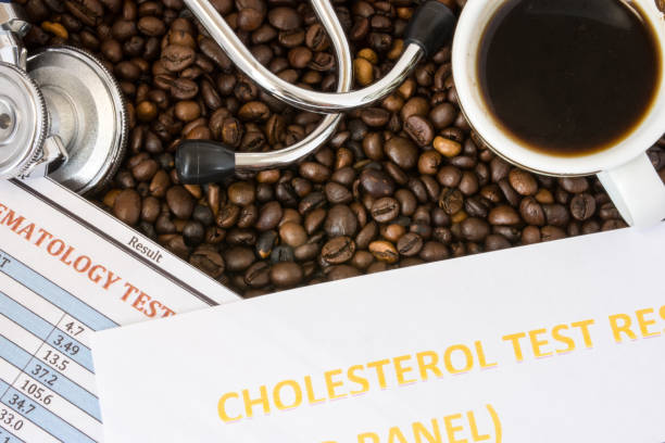 istock Complete blood count, cholesterol test result or lipidogram, medical stethoscope and a mug of coffee are on background of coffee beans. Positive or negative effect of coffee and caffeine on blood 902706514