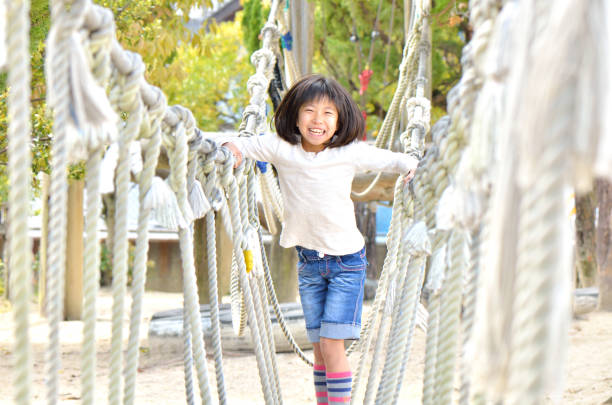 istock Girls playing in the park 902712254