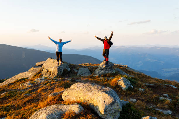 istock Couple standing on a rocks in mountains 902712594