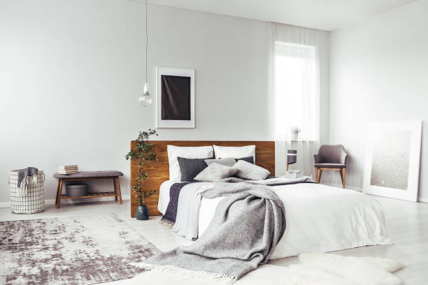 Dark poster in bright bedroom