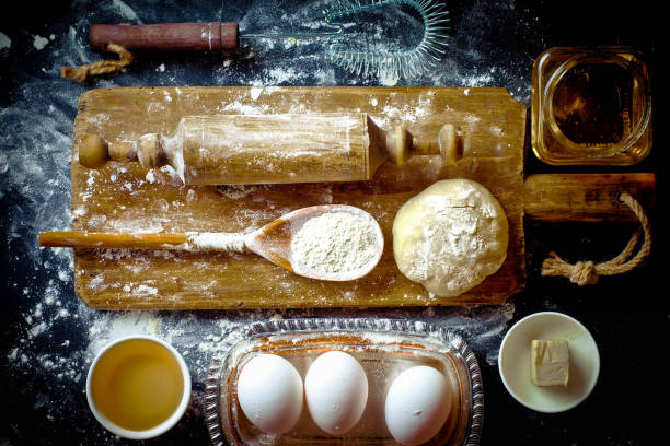 istock Dough and flour on an old background 902716640