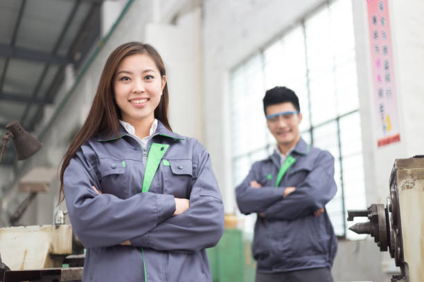 young chinese man and woman work in motor manufacturing factory