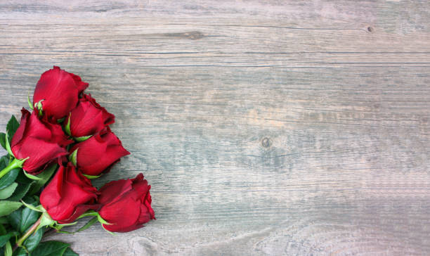 Valentine's Day Red Roses Over Wood Background Valentine's Day Red Roses Over Wood Background, Horizontal, Copy Space wide screen photos stock pictures, royalty-free photos & images