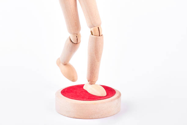 istock Legs of human wooden dummy on white. 902731604