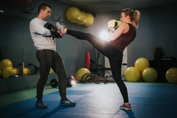 istock Female Boxer Training with Coach in the Gym 902734442