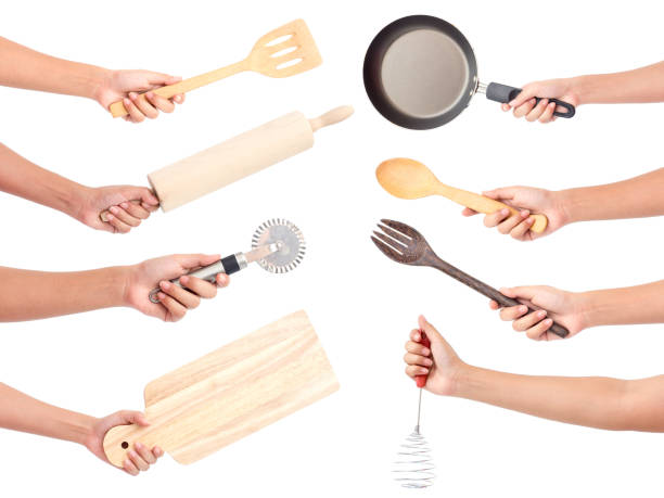 istock Chef's hands holding kitchen utensils/many equipment for food isolated on white background 902740146