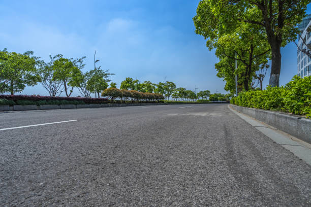 istock Asphalt road and green trees under blue sky 902758396