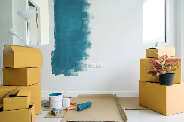 istock Stack of cardboard boxes and painting equipment 902770510