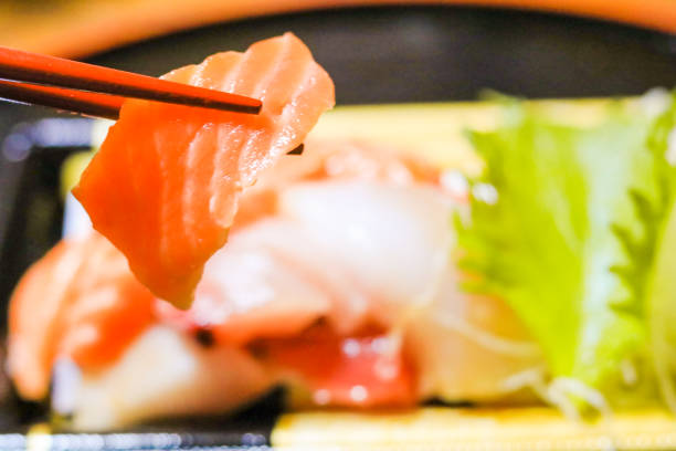istock Japanese food,sashimi with chopsticks. 902770778