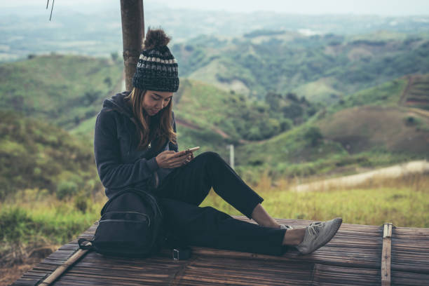 istock Young woman traveler using smart phone with beautiful landscape 902774248