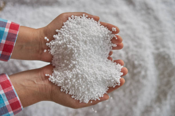 istock Nitrogen fertilizers or urea fertilizer in farmer hand. blurwhite fertilizer background. 902779498